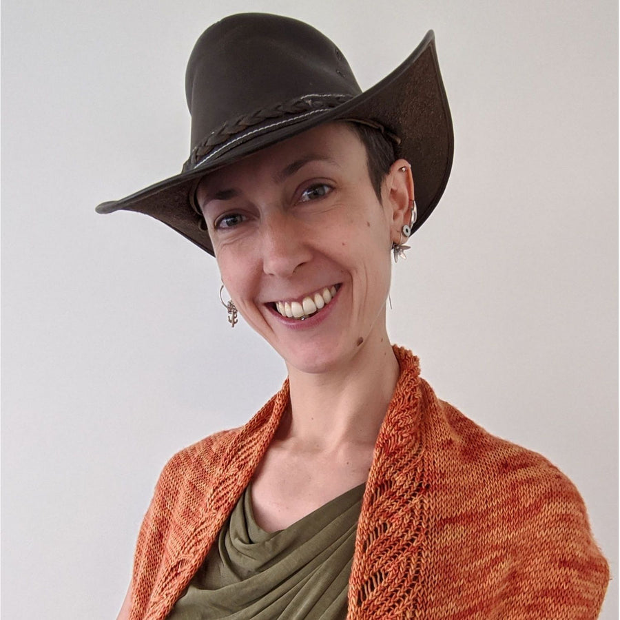 Person wearing cowboy hat and shawl